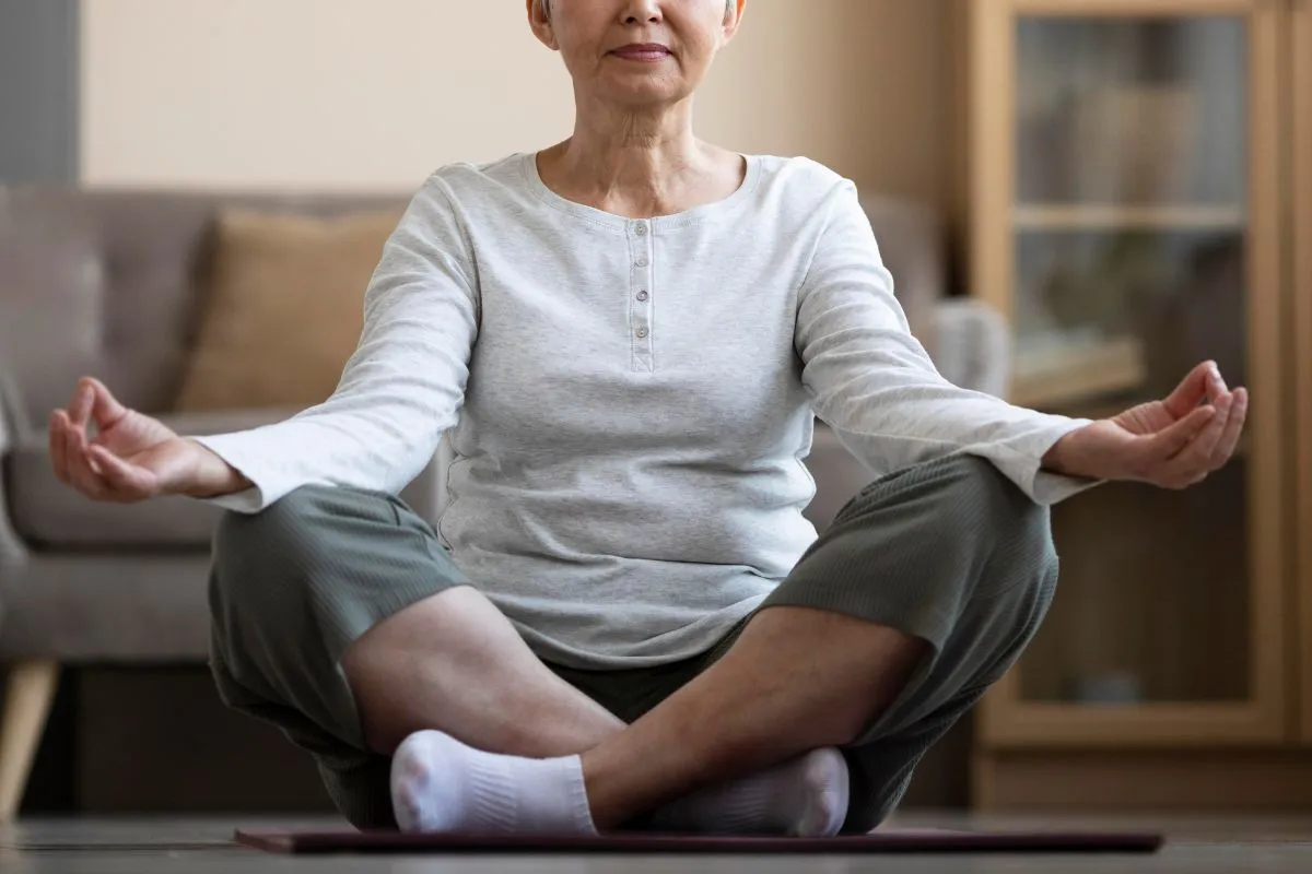 Older adult doing gentle seated stretching for leg circulation. 